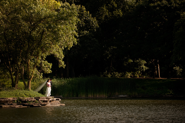 Bride and groom by a lake - wedding photo by Kenny Nakai Photography